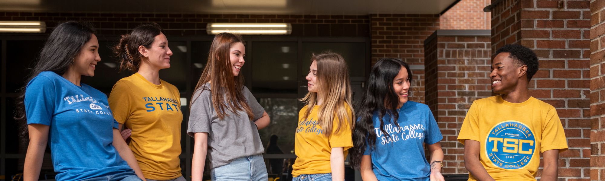 Tallahassee State Students sitting together on the student union staircase.