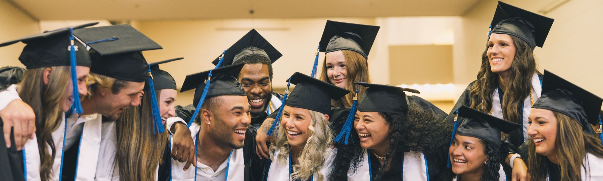 Smiling graduates in a group of friends