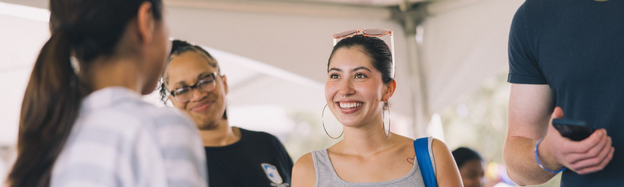 Student smiling at convocation table.