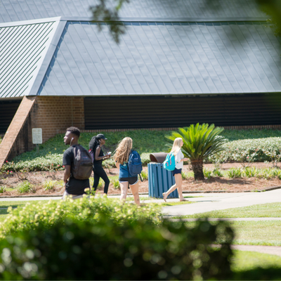 Students walking on campus on a sunny day