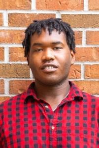 O.J. standing in front of a brick wall